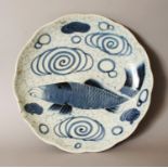 AN 18TH CENTURY JAPANESE EDO PERIOD BLUE & WHITE PORCELAIN DISH, with a scalloped rim, painted