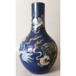 A LARGE 19TH CENTURY CHINESE BLUE GROUND PORCELAIN BOTTLE VASE, the sides decorated in underglaze-