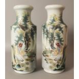 A MIRROR PAIR OF CHINESE REPUBLIC STYLE PORCELAIN ROULEAU VASES, each decorated with a seated