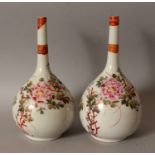 A PAIR OF EARLY 20TH CENTURY JAPANESE ENAMEL DECORATED PORCELAIN BOTTLE VASES, 8.7in high.