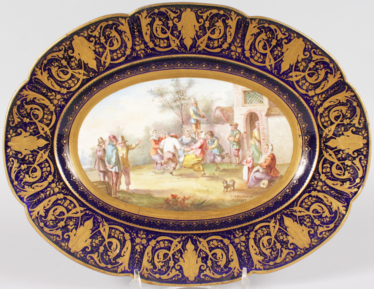 A GOOD SEVRES PORCELAIN OVAL DISH, painted with figures revelling by ALBERT, with blue and gilt