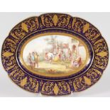 A GOOD SEVRES PORCELAIN OVAL DISH, painted with figures revelling by ALBERT, with blue and gilt