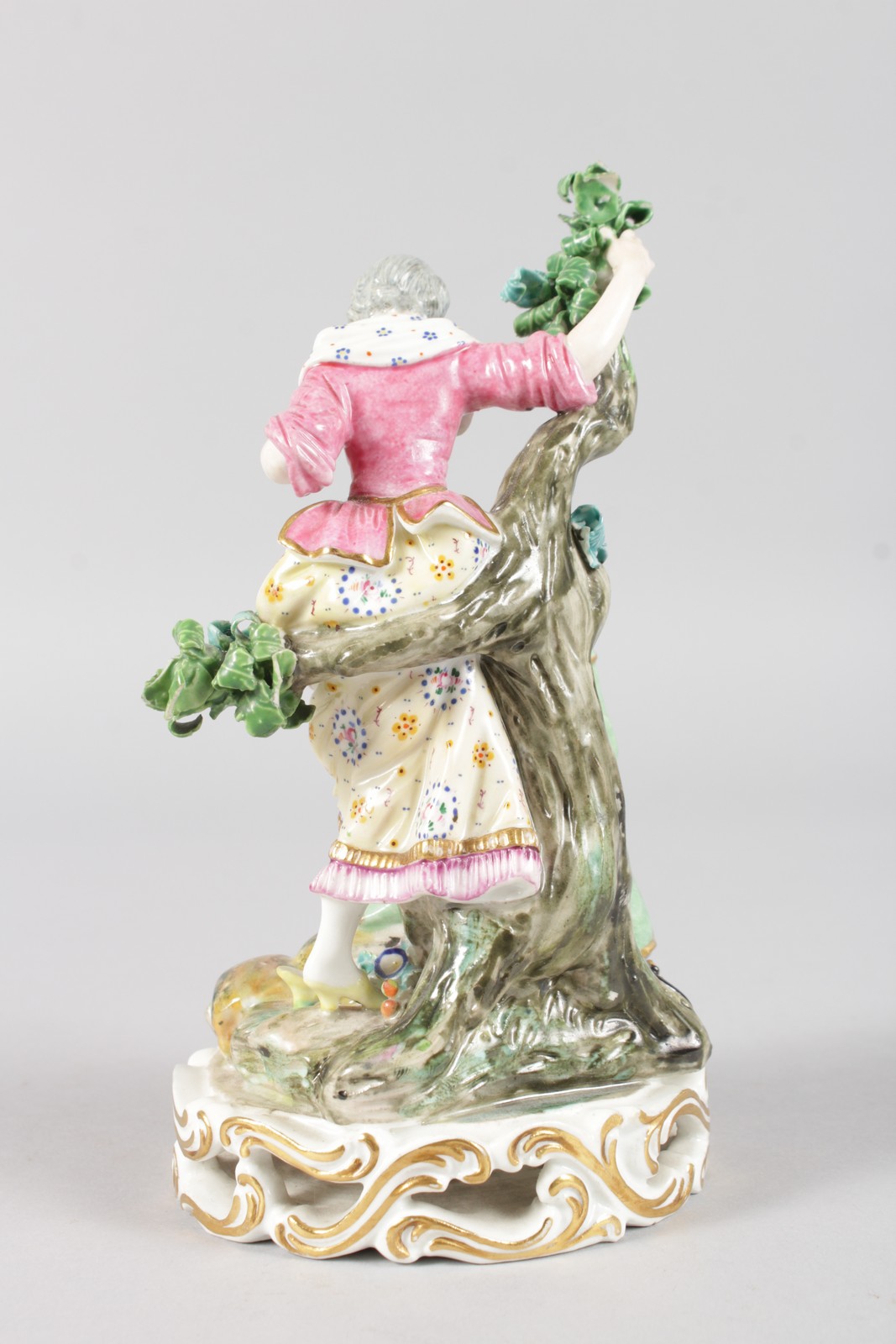 AN EARLY 19TH CENTURY DERBY FIGURE OF A SHOE BLACK, kneeling in front of a tree, holding a woman's - Image 4 of 4