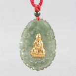 A JADE AND GOLD PENDANT.