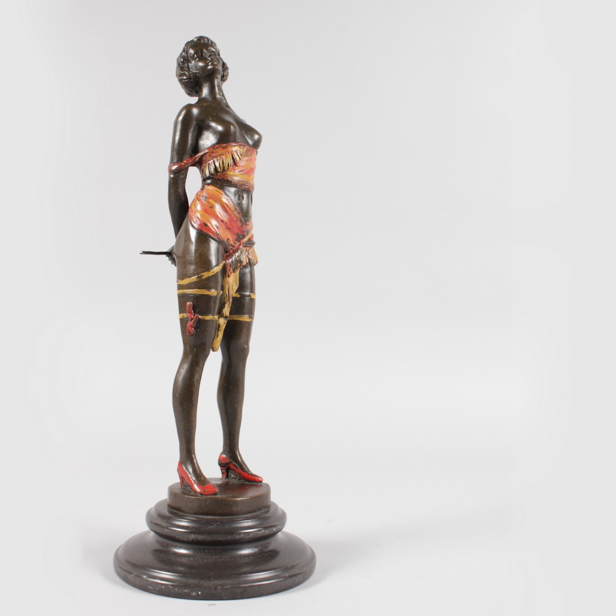 AFTER BRUNO ZACH A BRONZE GILDED SEMI CLAD STANDING GIRL, holding a whip. Signed, on a circular