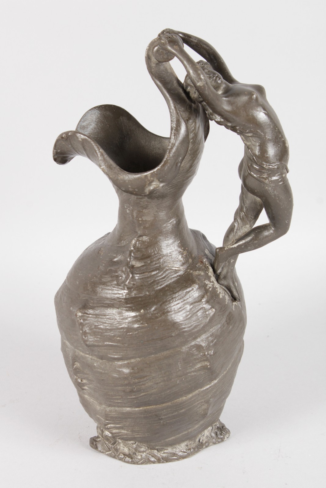 AN ART NOUVEAU BRONZED CLASSICAL EWER, the handles as a nude. 10ins high.