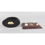 AN OVAL BOX with ivory elephant handle, 5ins long, and a similar PLAQUE, 6ins long (2).