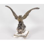 A GOOD BRONZE OF AN EAGLE, wings outstretched with laurel wreath, on a square veined marble base.