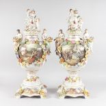 A LARGE PAIR OF DRESDEN STYLE TWO HANDLED URNS, COVERS AND STANDS, the lids with crest and two