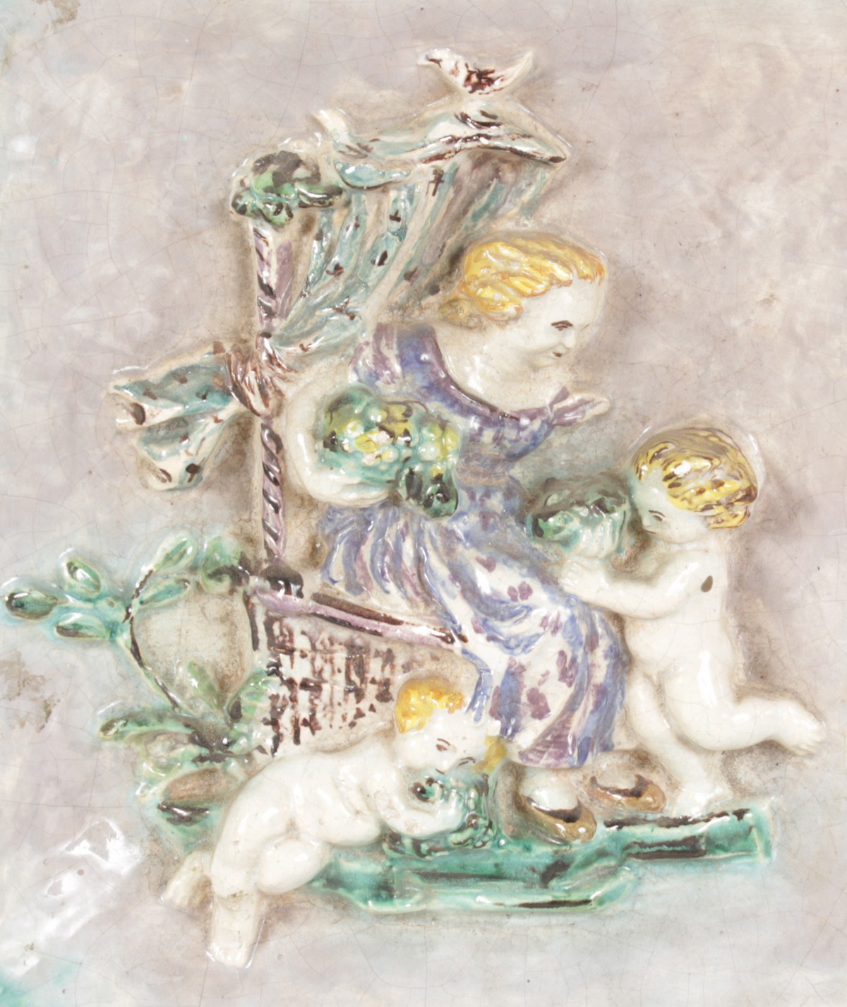 A FAIENCE SQUARE COLOURED TILE, a lady on a chair with two cupids in relief. 11ins x 10ins. - Image 2 of 2