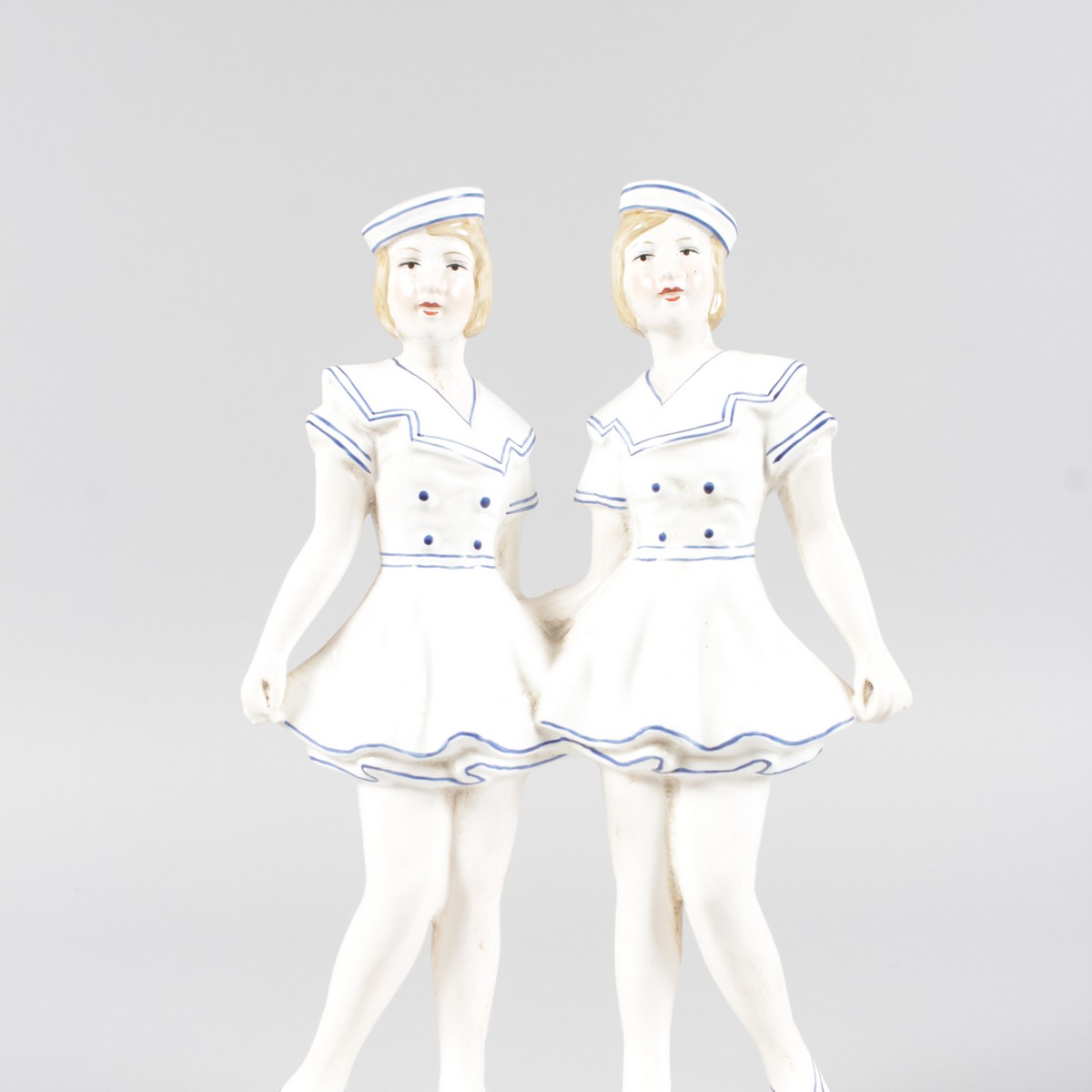 AN ART DECO DESIGN BLUE AND WHITE GROUP OF TWO GIRLS. 12ins high.
