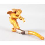 A GOOD MEERSCHAUM AND AMBER CIGARETTE HOLDER, carved with a winged cupid playing a pipe with two