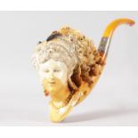 A SUPERB LARGE MEERSCHAUM PIPE, with silver band and amber mouthpiece, the bowl carved as the head