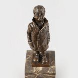 NAM GREB A SMALL BRONZE OF A BOY STANDING, HIS HANDS IN HIS POCKETS. Signed. 6ins high.