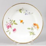 AN EARLY 19TH CENTURY SWANSEA PLATE painted with colourful flower sprays and gold border impressed