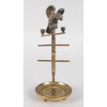 A SMALL FRENCH METAL CIRCULAR RING STAND, surmounted by an eagle. 6ins high.