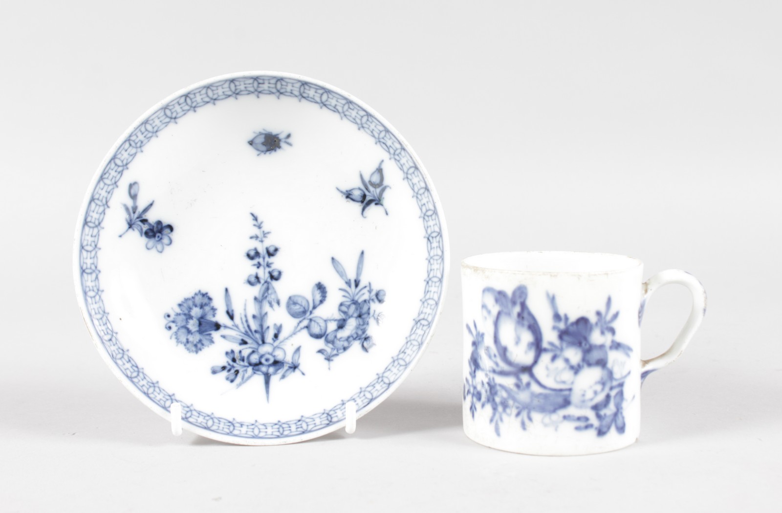 AN 18TH CENTURY MEISSEN BLUE AND WHITE CUP AND SAUCER.