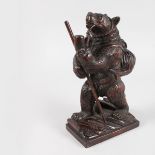 A GOOD CARVED WOOD BLACK FOREST STANDING CLIMBING BEAR with stick, pipe in his mouth and bag on