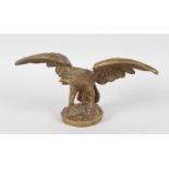 A BRONZE OF THE AMERICAN EAGLE, wings outstretched on a circular base. 8ins wide, 4ins high.