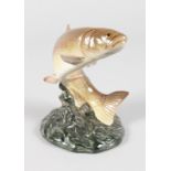 A BESWICK PORCELAIN LEAPING TROUT, No. 1052, on a shaped oval base. 6.5ins high.