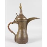 AN ISLAMIC COPPER LIDDED JUG. 12ins high.