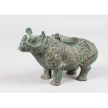 AN ISLAMIC BRONZE RHINO with cast scroll decoration and hinged lid. 7ins long.