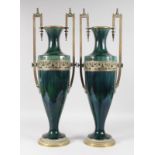 A GOOD PAIR OF LARGE GREEN PORCELAIN TWO HANDLED TAPERING VASES with large gilt metal handles and