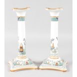 A PAIR OF COALPORT CHINESE WILLOW PATTERN CHINA CANDLESTICKS. 8ins high.