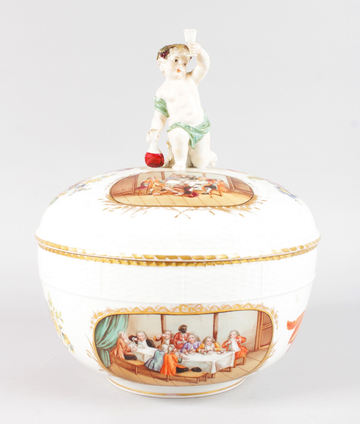 A GOOD BERLIN CIRCULAR PUNCH BOWL AND COVER, with cupid handle, two oval interior scenes and
