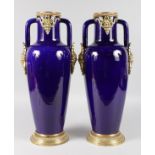 A GOOD PAIR OF SEVRES RICH BLUE PORCELAIN AND TWO HANDLED TAPERING VASES with gilt metal mounts