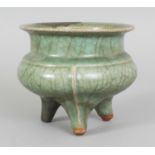 A CHINESE SOUTHERN SONG DYNASTY LONGQUAN CELADON TRIPOD CENSER, formerly from the collection of