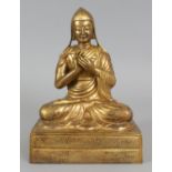A LARGE GOOD QUALITY TIBETAN GILT BRONZE FIGURE OF A LAMA PRIEST, seated in dhyanasana on a
