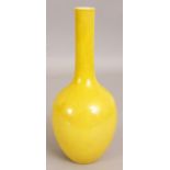 A CHINESE YELLOW GLAZED MONOCHROME PORCELAIN BOTTLE VASE, the base with a Qianlong seal mark, 8.75in