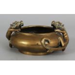 AN EARLY 20TH CENTURY CHINESE POLISHED BRONZE CENSER, weighing 1.53gm, the sides cast in relief with