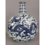 A LARGE CHINESE MING STYLE BLUE & WHITE DRAGON MOON FLASK, each domed surface decorated with a