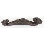 AN UNUSUAL LARGE CHINESE WOOD RUYI SCEPTRE, possibly Zitan, carved in high relief with bats, 'cash',