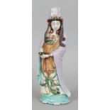 A JAPANESE KUTANI PORCELAIN FIGURE OF KWANNON, circa 1900, standing in flowing robes and bearing a