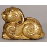 A SMALL CHINESE HAN STYLE GILT BRONZE MODEL OF A RECUMBENT KYLIN, possibly early, cast with