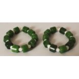 A PAIR OF CHINESE GREEN & WHITE JADE-LIKE BRACELETS.