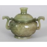 A CHINESE CELADON GREEN JADE LIKE CENSER & COVER, of archaic form with scroll handles, the sides