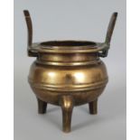 A 19TH CENTURY CHINESE POLISHED BRONZE TRIPOD CENSER, weighing 1.44Kg, cast with a band to the
