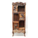 A 19TH/20TH CENTURY CHINESE TALL HARDWOOD DISPLAY CABINET, the doors and panels carved in high