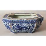 A CHINESE MING STYLE BLUE & WHITE PORCELAIN DRAGON JARDINIERE, of rectangular form with indented