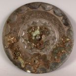 A CHINESE SILVERED BRONZE CIRCULAR MIRROR, possibly Song Dynasty, the top surface with formal