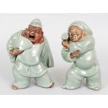 A PAIR OF EARLY 20TH CENTURY JAPANESE CELADON GLAZED PORCELAIN FIGURES OF DAIKOKU & EBISU, their