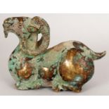 A 20TH CENTURY CHINESE GILT BRONZE MODEL OF A RECUMBENT RAM, with pronounced green patination, 4.1in