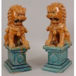 A PAIR OF LARGE 20TH CENTURY CHINESE GLAZED POTTERY MODELS OF TEMPLE GUARDIAN LIONS, each applied in