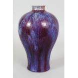 A GOOD QUALITY CHINESE FLAMBE GLAZED MEIPING PORCELAIN VASE, the sides applied with a streaked