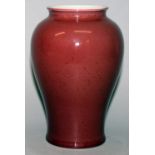 A CHINESE SANG-DE-BOEUF PORCELAIN VASE, the glaze slightly mottled, the base unglazed, 7.5in high.