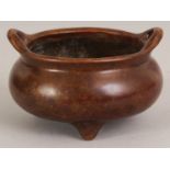 A CHINESE BRONZE TRIPOD CENSER, weighing 610gm, the base with a Qianlong seal mark, 4.6in wide at